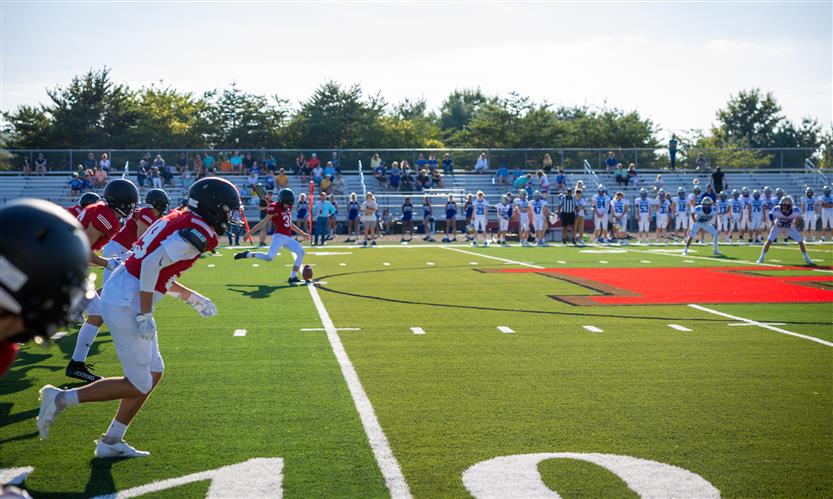 A football team kicks off the ball